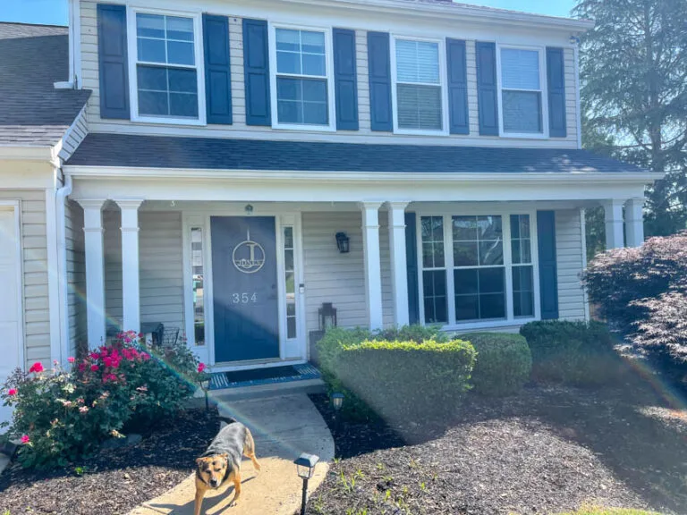 Two-story home with new windows and a covered entry