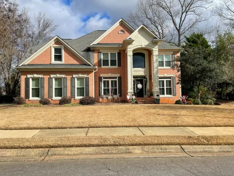 Brick and stone home with new windows across the front