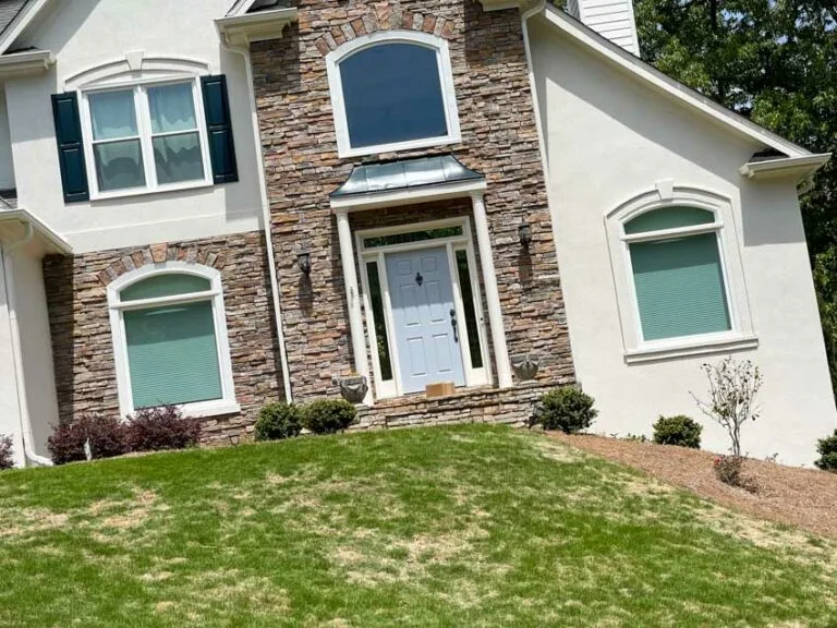 Stone-front home with new white windows