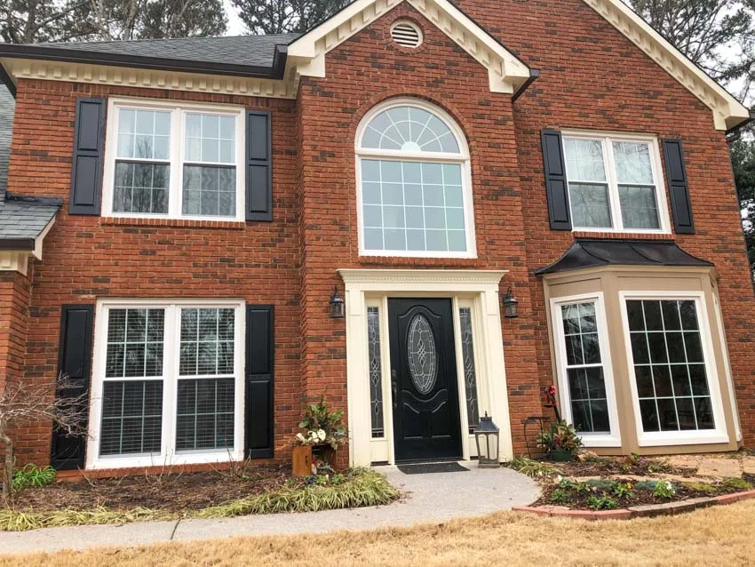 Brick two-story home in the Marietta area with new white replacement windows