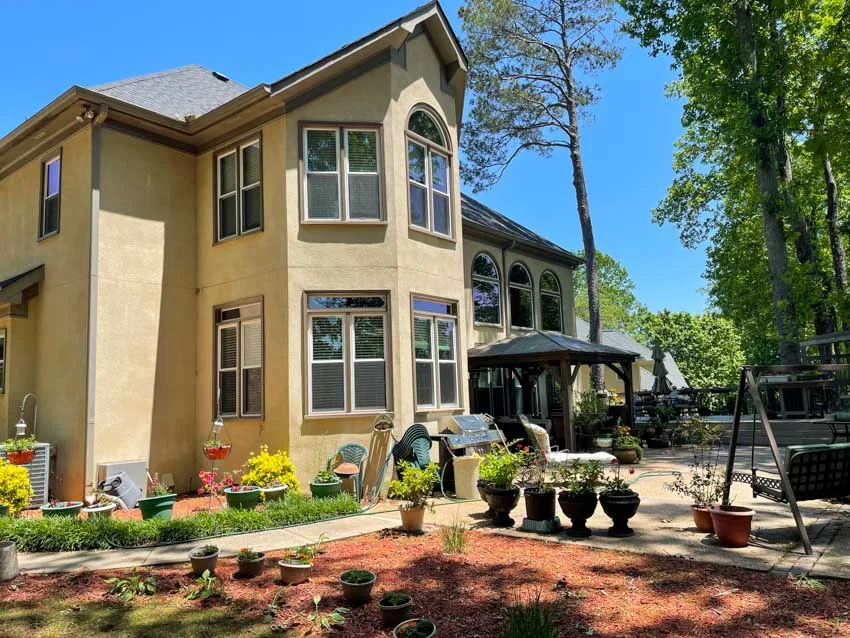Stucco home with new windows and arched transom